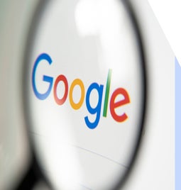Magnifying glass over the Google search homepage