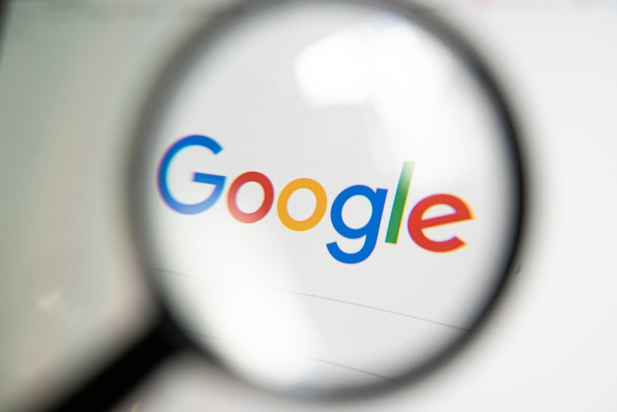 Magnifying glass over the Google search homepage