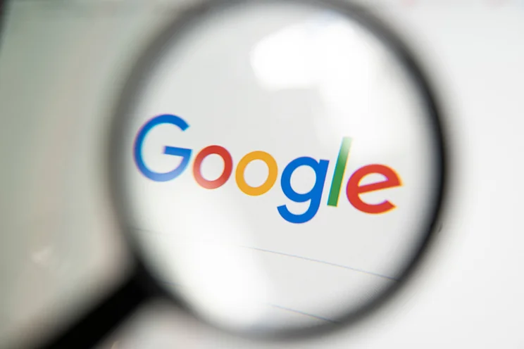 Magnifying glass over the Google search homepage
