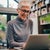 Woman with glasses working at a laptop in her home