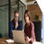 Man and woman working together at a laptop in an office space
