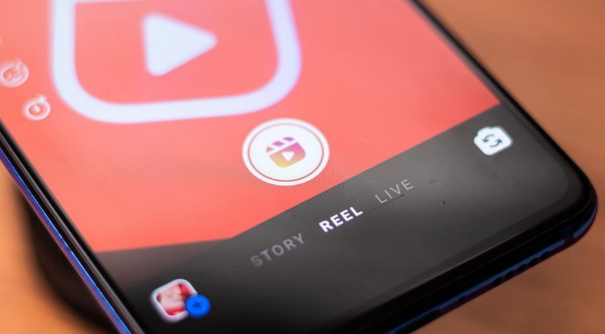 How To Find Trending Instagram Audios Intro Close-up of a smartphone screen displaying a video app interface with options for 'Story,' 'Reel,' and 'Live' highlighted.