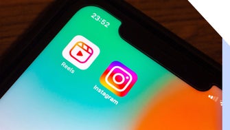 Close-up of a smartphone screen displaying the Instagram and Reels app icons against a gradient background