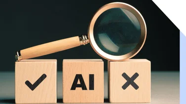 A magnifying glass rests on wooden blocks labeled with a checkmark, "AI," and an "X," symbolizing evaluation and choices in AI.