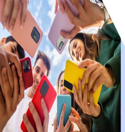 Circle of friends holding their phones together