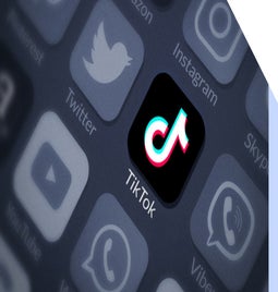 TikTok app logo highlighted with greyed out social media icons around it