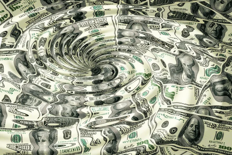 US dollars distorted by a water whirlpool