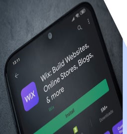 Wix app on a smartphone screen showcasing its features for building websites, online stores, and blogs, with an Install button.
