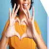 Person making a love heart sign with their hands