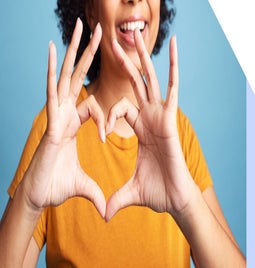 Person making a love heart sign with their hands