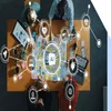 Team sitting and working around a table with icons floating above showing AI icons and other digital tools