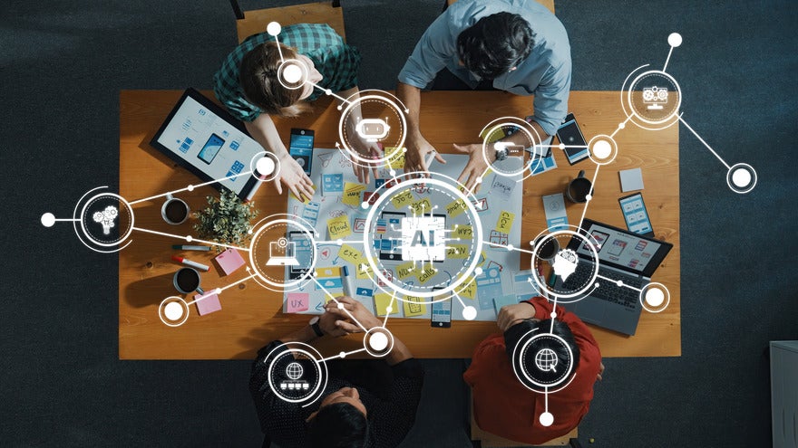 Google SMB digital hub Team sitting and working around a table with icons floating above showing AI icons and other digital tools