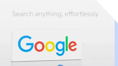 Close-up of Google logo on a white background with the text "Search anything, effortlessly" blurred in the rear.