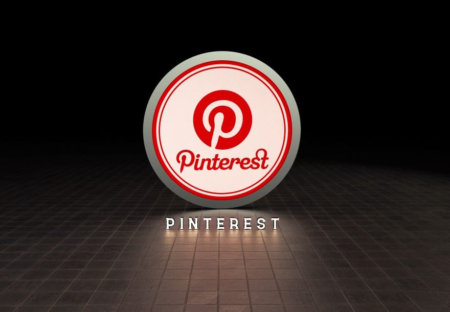 Illuminated Pinterest logo on a dark background, featuring a red circular design with the name "Pinterest" below in bold letters.