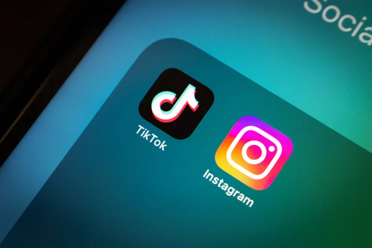 close up of iPhone app folder with TikTok and Instagram in it