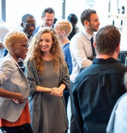 Group of people mingling and networking at an event