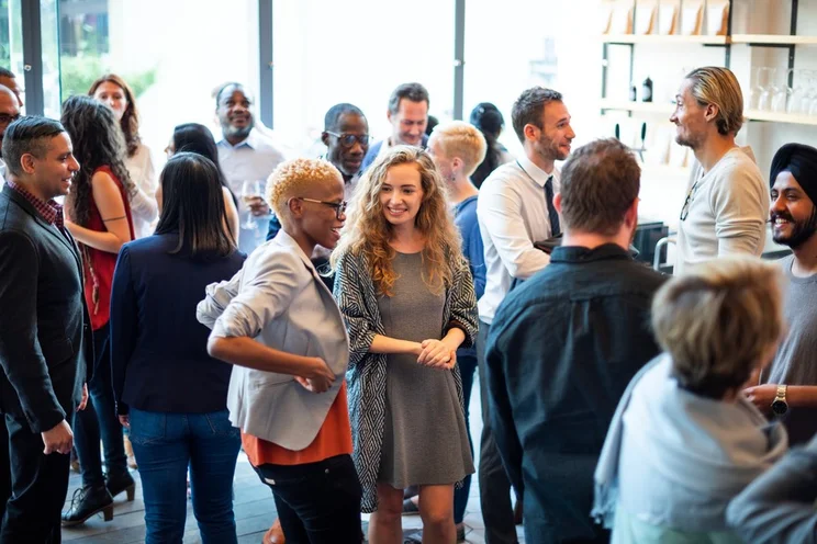 Group of people mingling and networking at an event