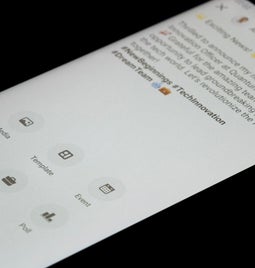 Close-up of a smartphone screen showing a social media post announcing a new role as Chief Technology Officer, with various icons below.