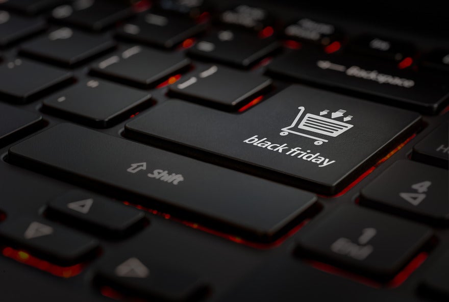 Pinterest Black Friday Tips Intro Close-up of a black keyboard highlighting a key labeled "black friday" with a shopping cart icon, set against a dimly lit background.