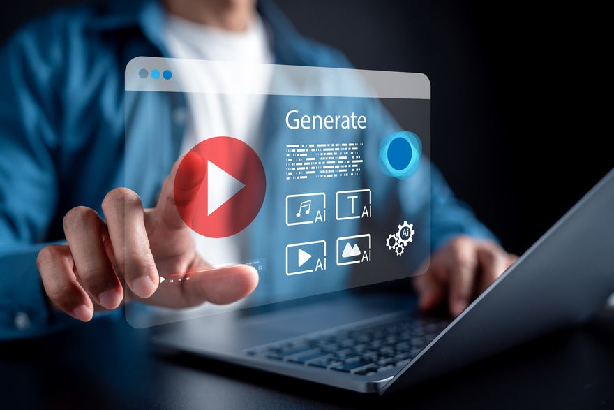 A person taps a holographic interface featuring a "Generate" button and various multimedia AI icons, while using a laptop.