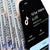 A smartphone displaying the TikTok app interface lies on a stack of hundred-dollar bills, highlighting digital media's connection to money.