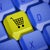 Keyboard buttons with a shopping cart button in yellow sitting replacing a letter button