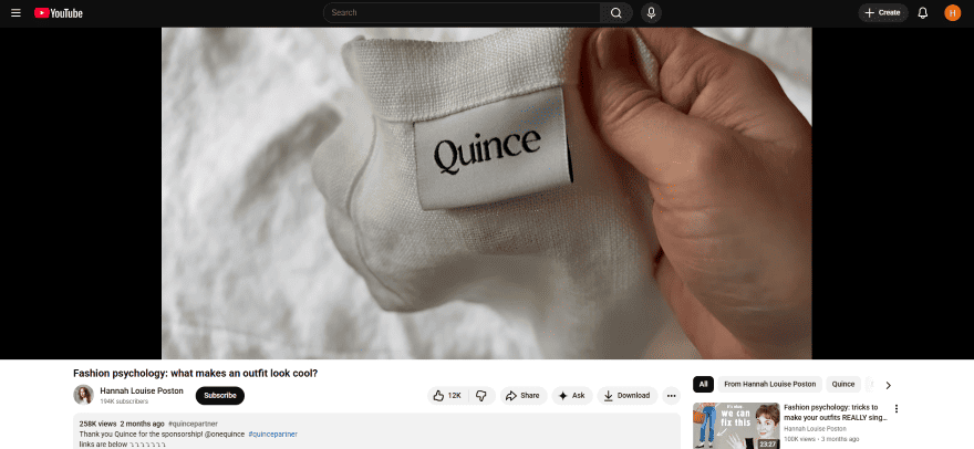 A paused YouTube video showing the presenter holding a branded item to the camera.