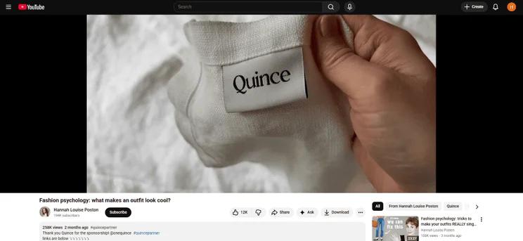 A paused YouTube video showing the presenter holding a branded item to the camera.