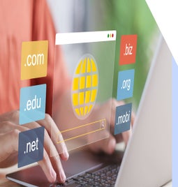 A person typing on a laptop surrounded by floating top level domains like .com, .edu, and .org, symbolizing web browsing.