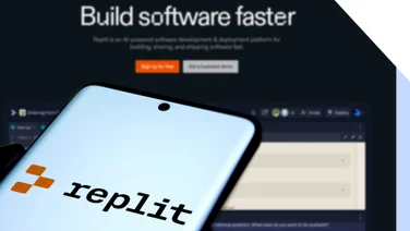 A smartphone displaying the Replit logo, with a dark website background promoting software development tools.