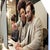 Two people looking at a computer screen with headsets on