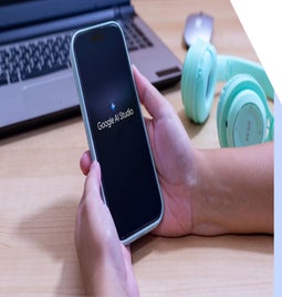 A person holds a smartphone displaying the 