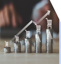 A stack of coins illustrating increasing growth, with shopping carts and upward arrows symbolizing rising sales or investments.
