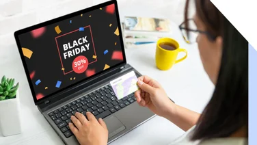 Black Friday sale on laptop screen with a woman ready to pay